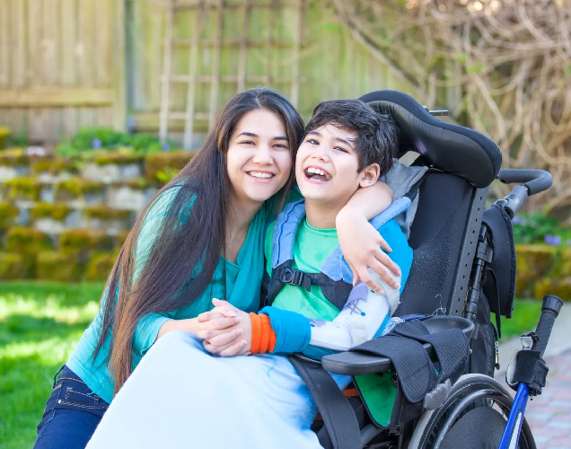 Image of a person happily sitting in their new accessible apartment